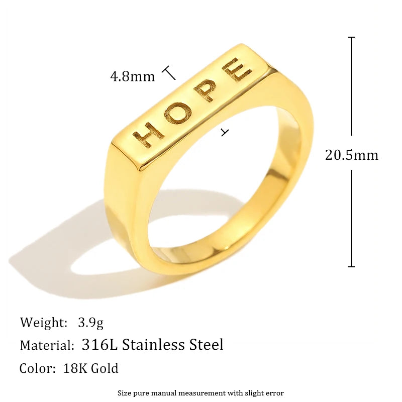 Gold ring with 'HOPE' engraving and measurements on a white background