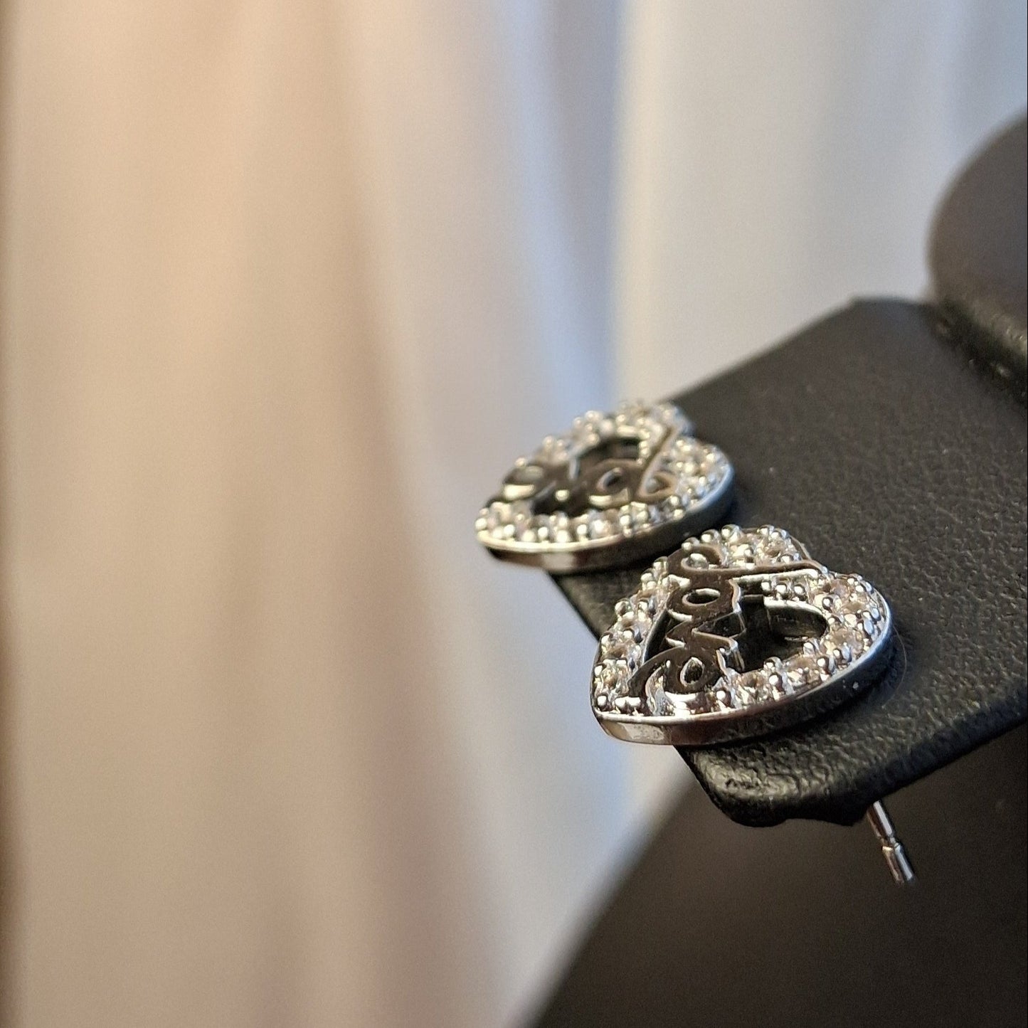 Heart-shaped earrings on a black background
