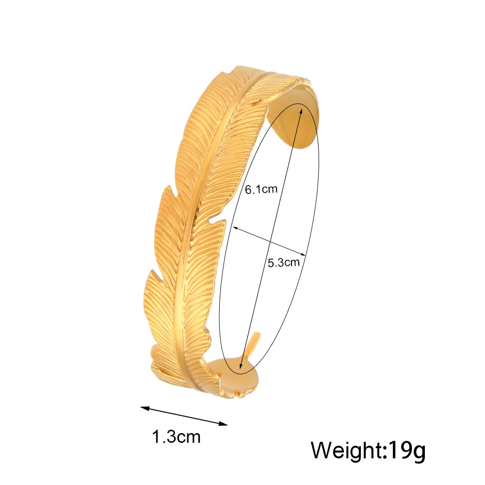 Gold feather-shaped bracelet with measurements and weight on a white background