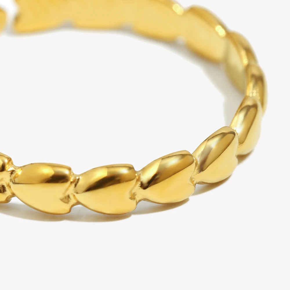 Gold heart ring on a white background