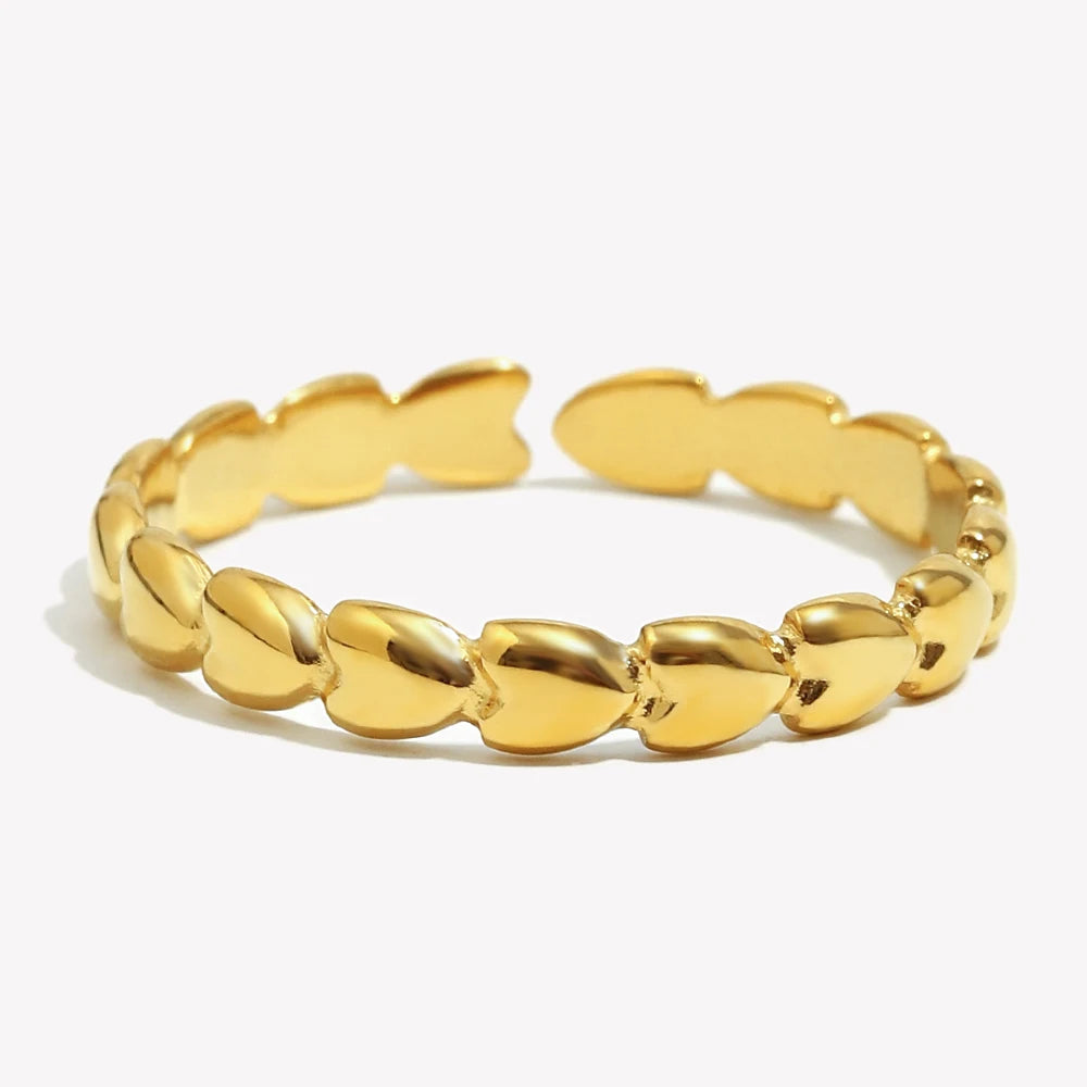 Gold heart ring with heart-shaped links on a white background