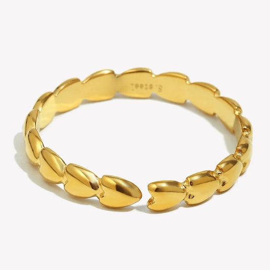Gold hearts linked ring with a textured design on a white background