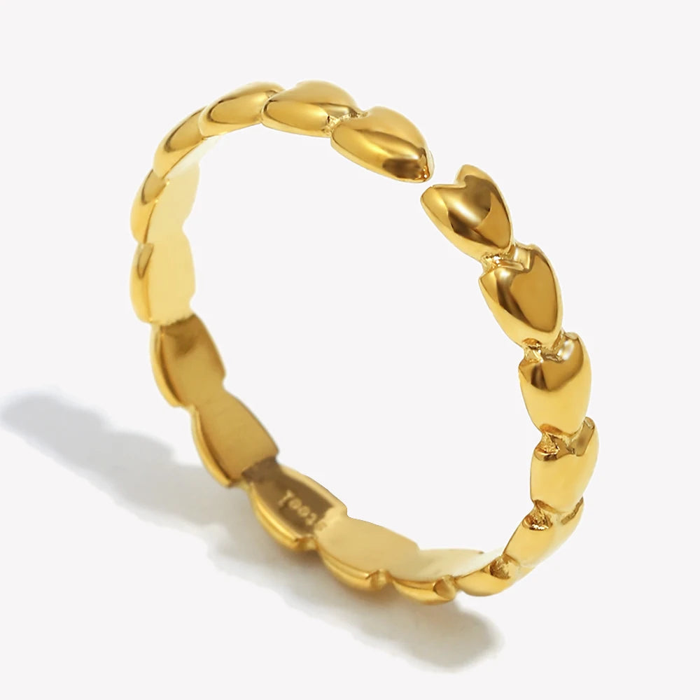 Gold ring with a textured band on a white background