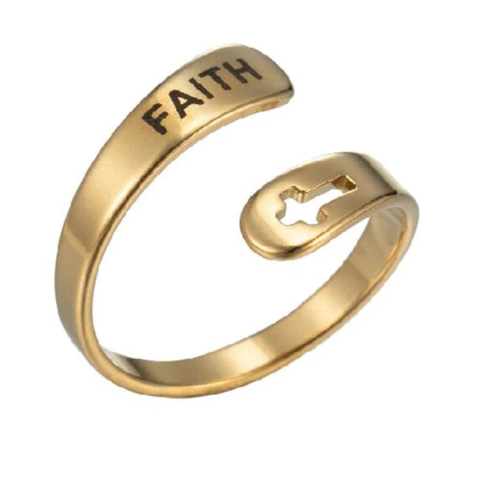 Gold ring with 'FAITH' engraving on a white background