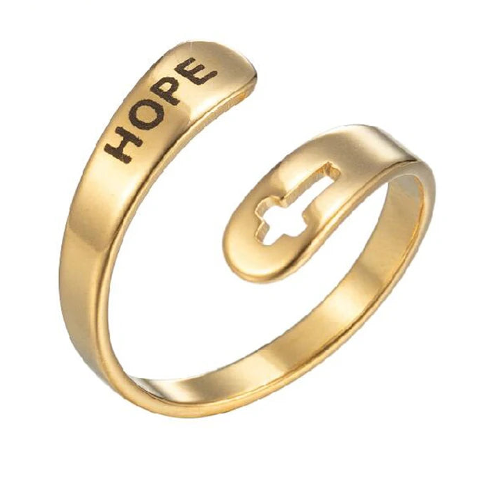 Gold ring with 'HOPE' engraving and cross design on a white background