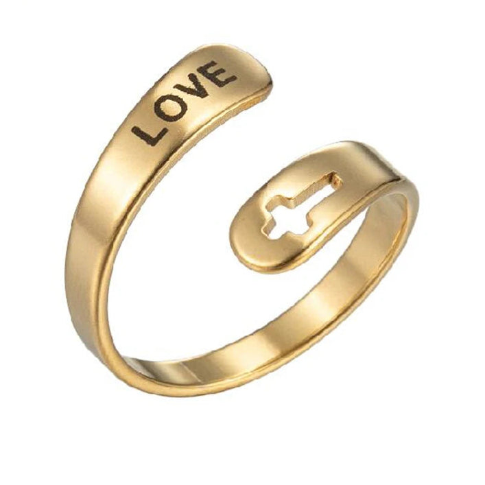 Gold ring with 'LOVE' engraving and cross design on a white background