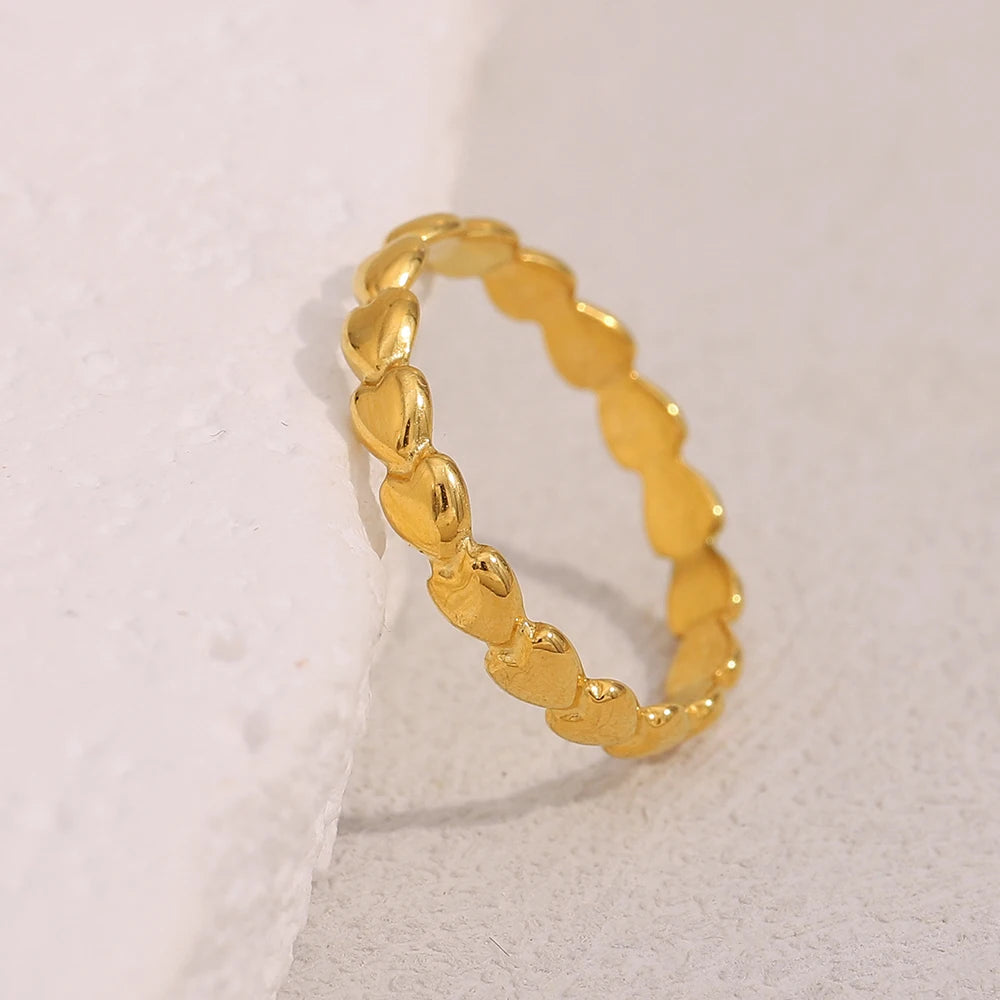 Gold ring with a textured band on a light gray background