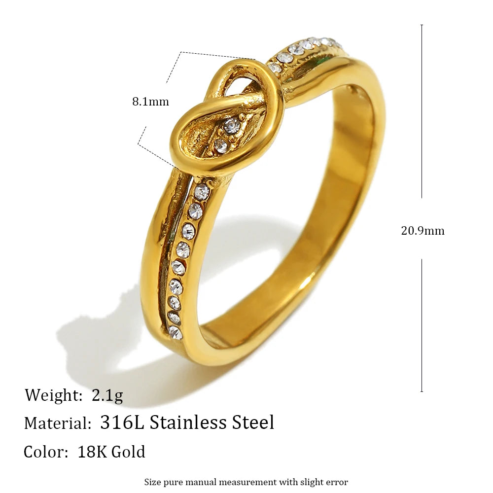 Gold ring with intricate design and measurements on a white background