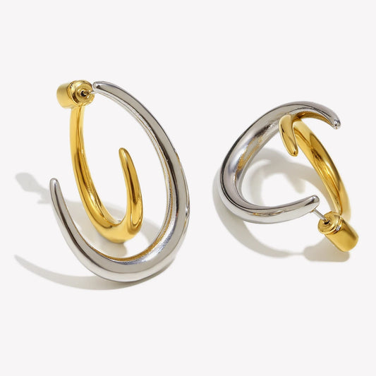 Pair of gold and silver hoop earrings on a white background