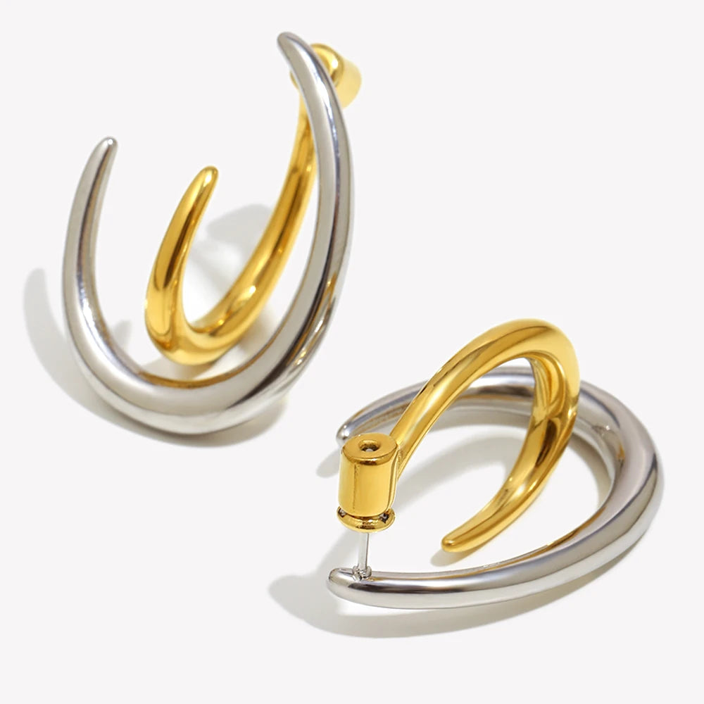 Pair of gold and silver hoop earrings on a white background