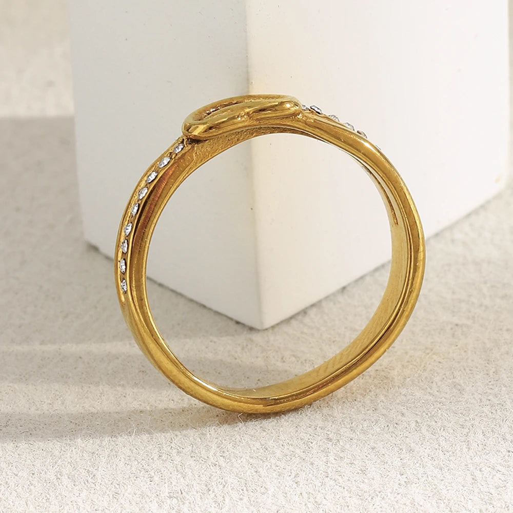 Side view of Gold ring with embedded stones on a light background