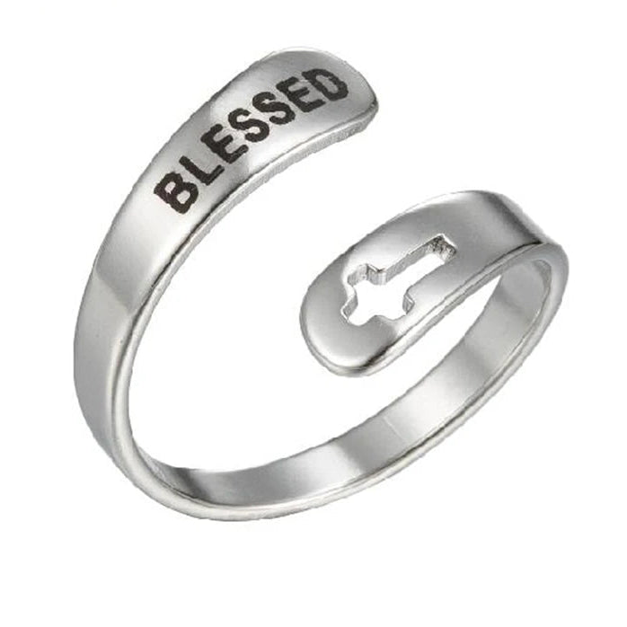 Silver ring with 'BLESSED' engraving and cross cut-out design on a white background