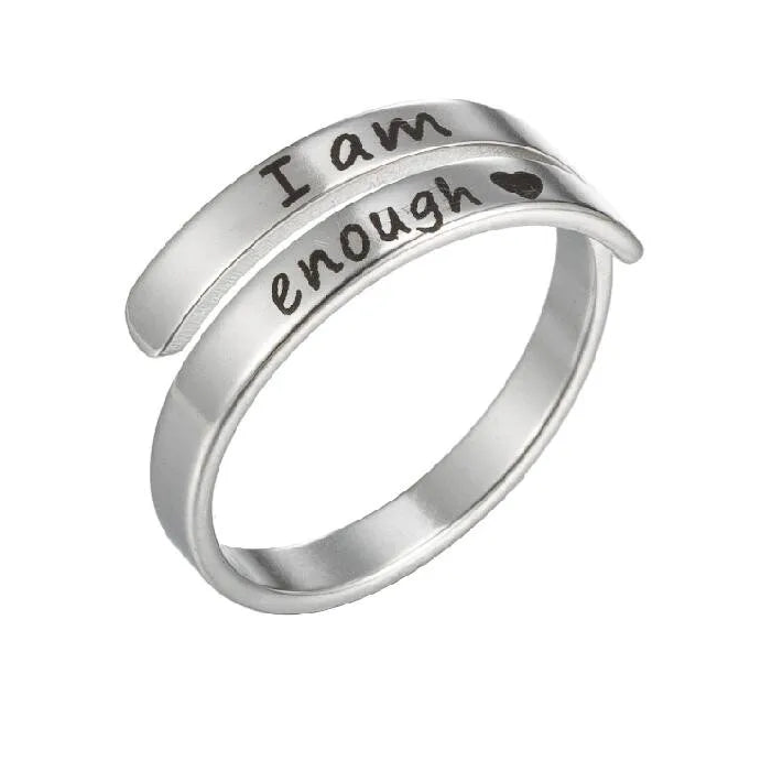 Silver ring with 'I am enough' engraving on a white background