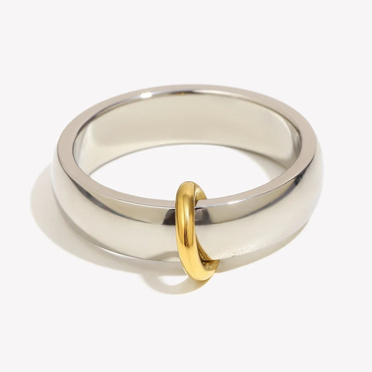 Silver ring with a gold loop on a white background
